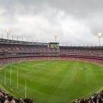 Panoramic view of a packed Melbourne Cricket Ground stadium.