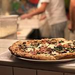 Freshly baked gourmet pizza on kitchen counter.