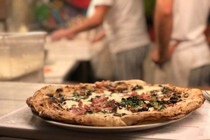 Freshly baked gourmet pizza on kitchen counter.