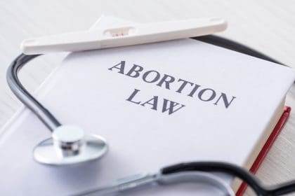 Abortion legislation text with stethoscope.