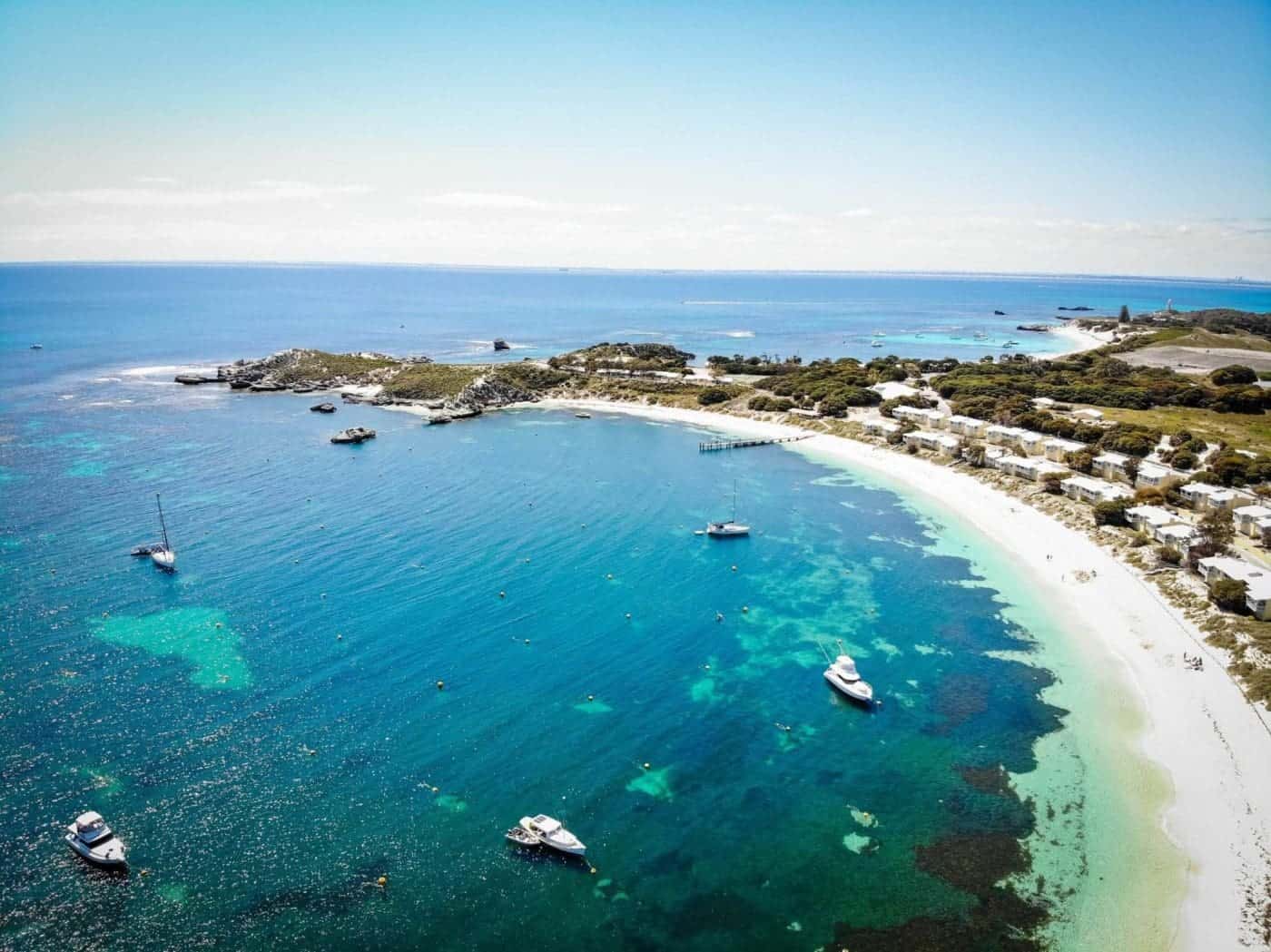 Aerial view of Perth coastline with boats and clear waters.