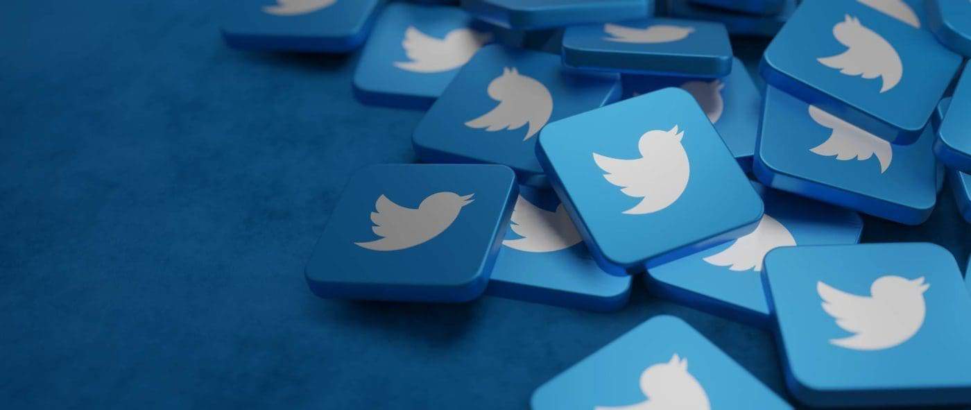 3D scattered Twitter bird icons on blue background