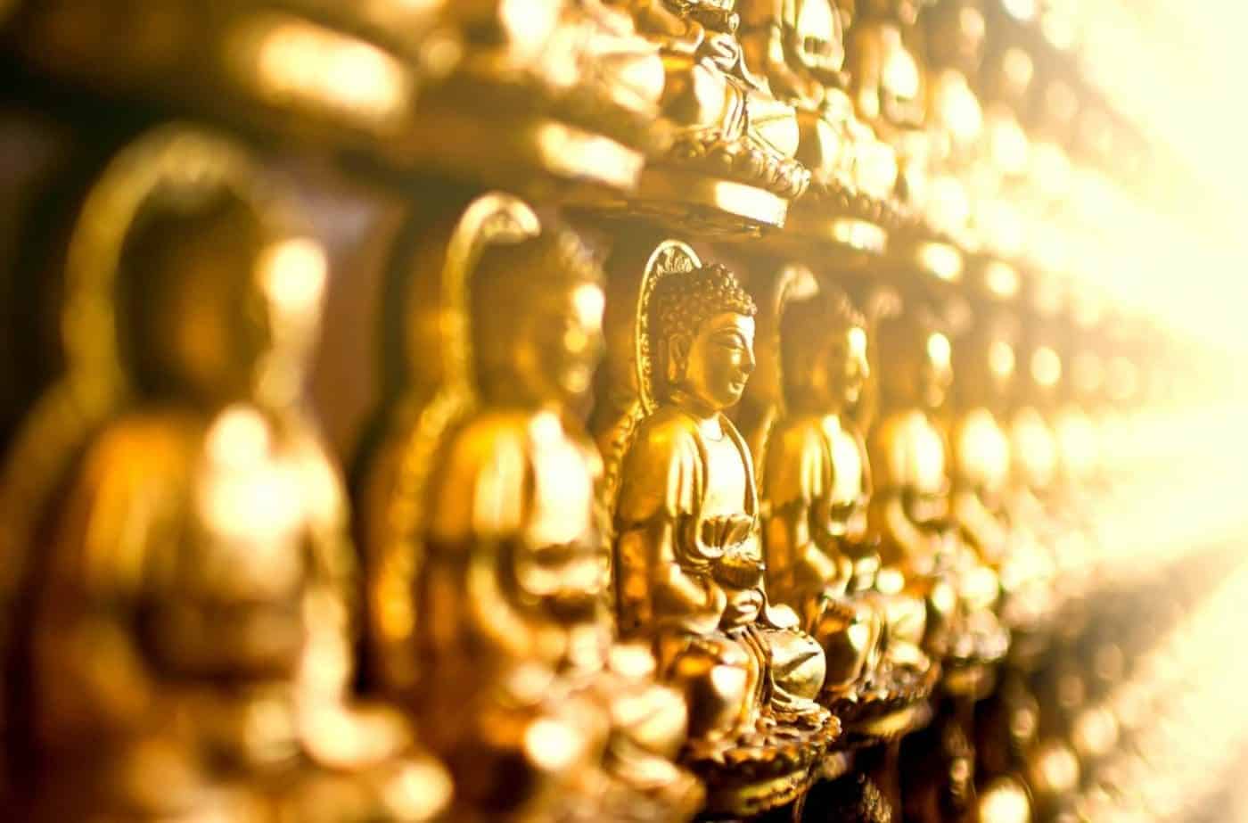 Golden Buddha statues in a row at a temple