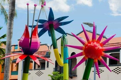 Colorful garden sculptures in a sunny outdoor art installation.