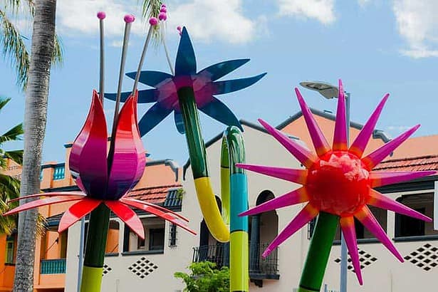 Colorful garden sculptures in a sunny outdoor art installation.