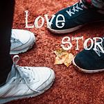 Couples Sneakers with Love Story Text on Ground.