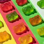 Colorful CBD gummy bears in a row.