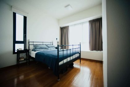Elegant modern bedroom with natural light and wooden floor.