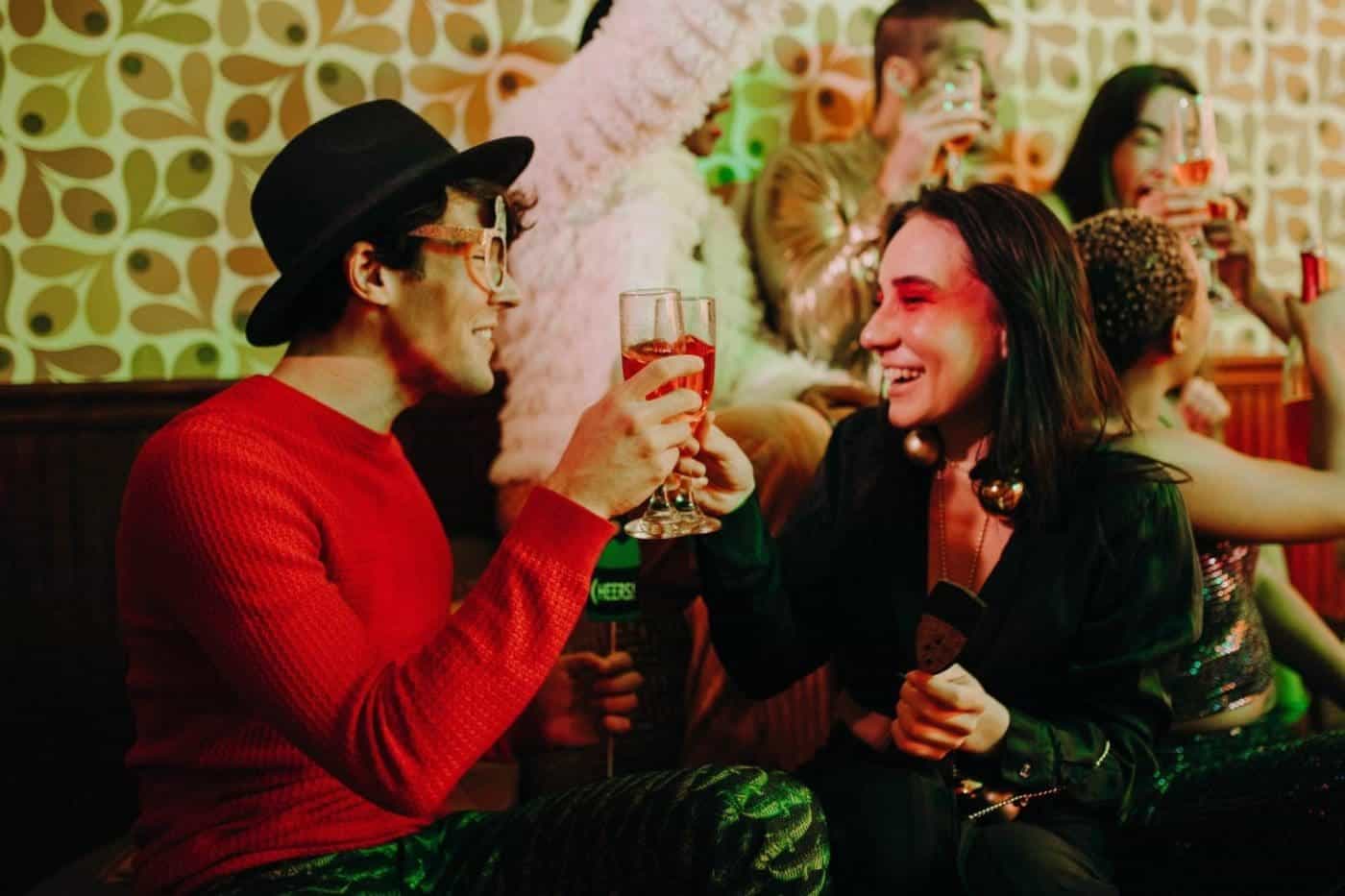 Friends toasting at a lively party celebration.