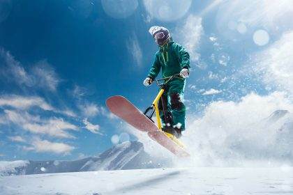 Snowboarder in mid-air during mountain jump.