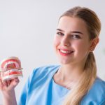 Dental nurse presenting denture cost options in Australia.