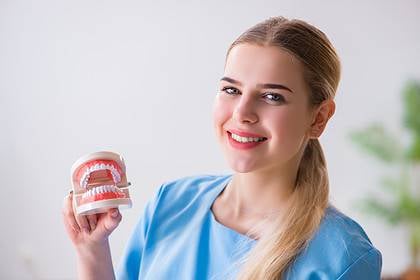 Dental nurse presenting denture cost options in Australia.