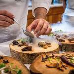 Chef garnishing gourmet meals in kitchen