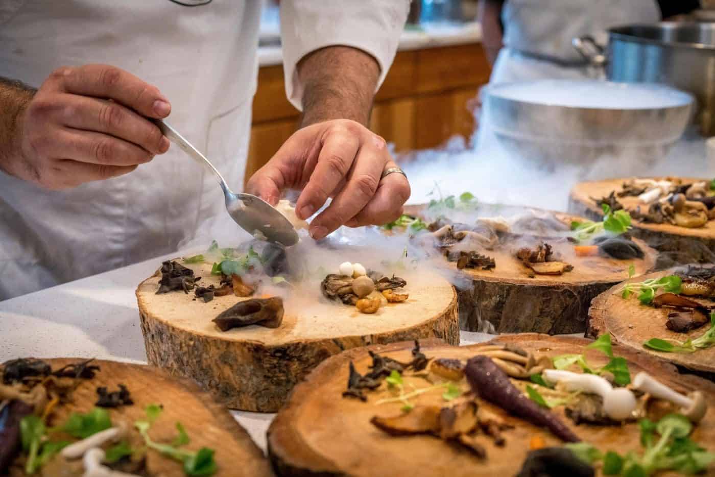 Chef garnishing gourmet meals in kitchen