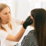 dermatologist examining patient skin