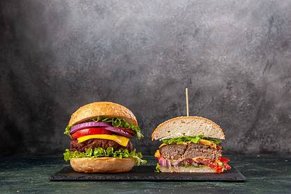 Double Quarter Pounder burgers on dark background.