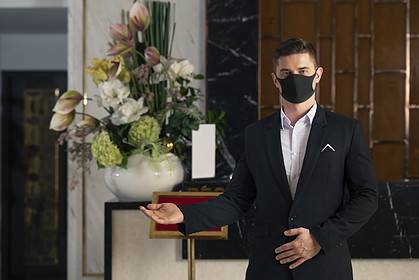Man in suit performing funeral celebrant duties.
