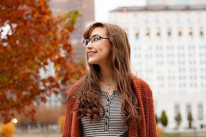 Woman smiling with braces in autumn setting