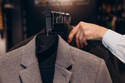 Choosing bespoke suits at a tailor shop.