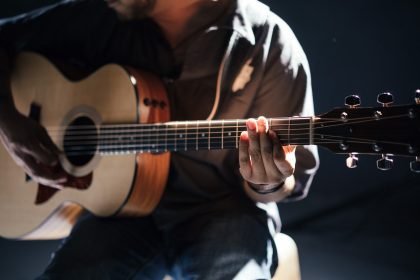 A man holding a guitar